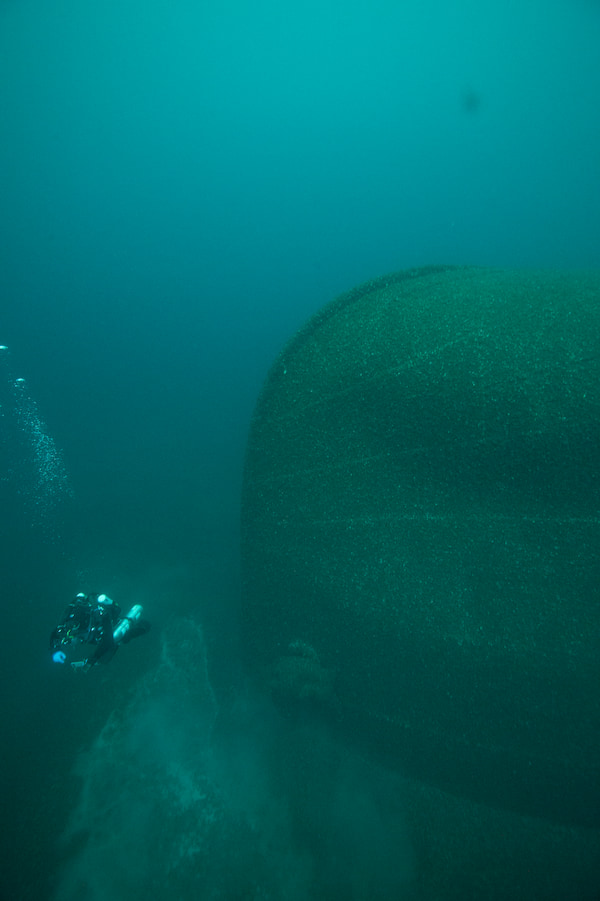 A diver swims away from the bow at the site of the overturned Isaac M. Scott