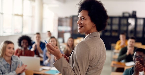 A female lecturer finishes a lesson for a university class.