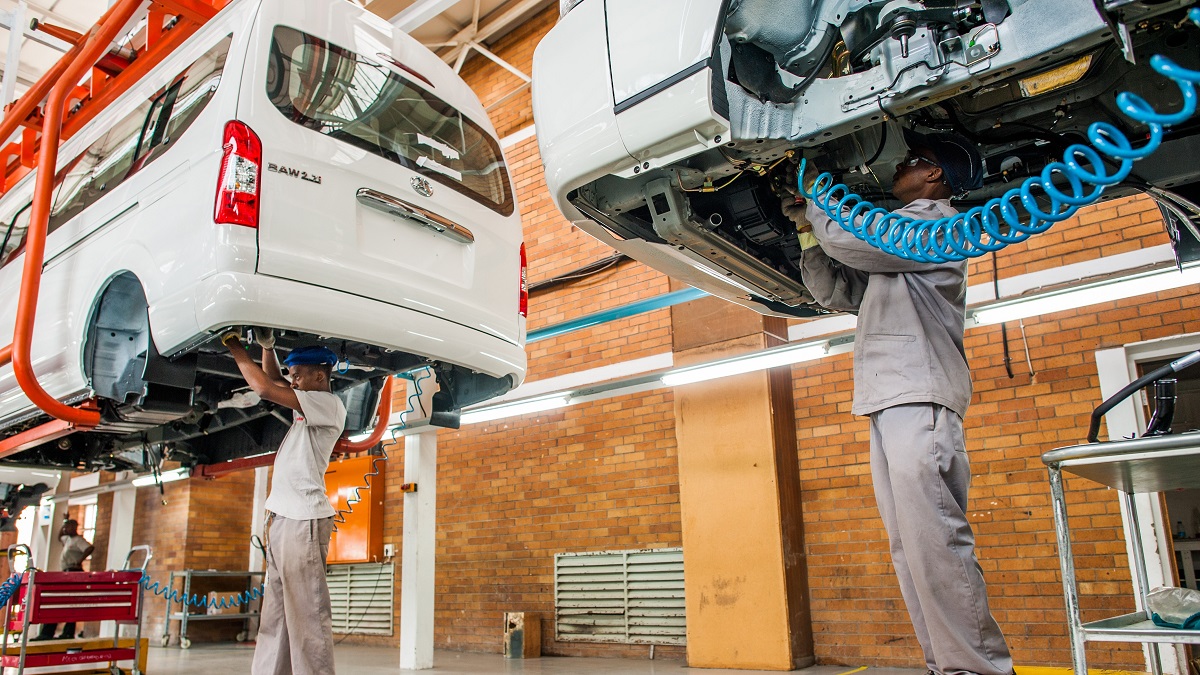 Workers assemble cars in a factory in South Africa