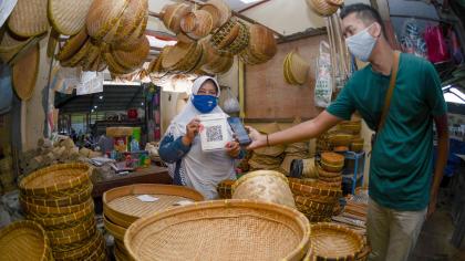 A bamboo craft seller uses a QR payment solution in Kediri, Indonesia.