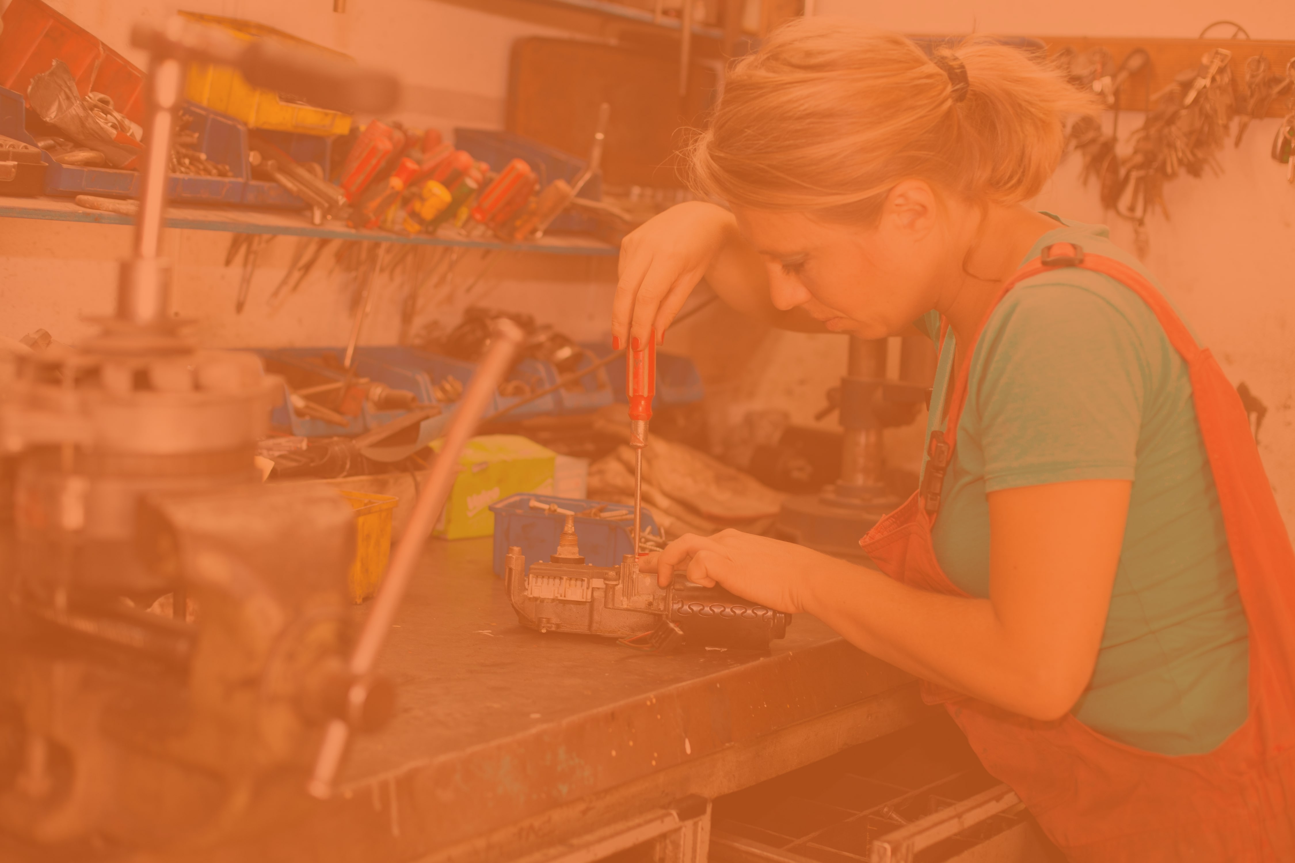 A woman working with a screwdriver.