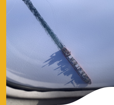 A panoramic image of ship crossing a frozen sea.