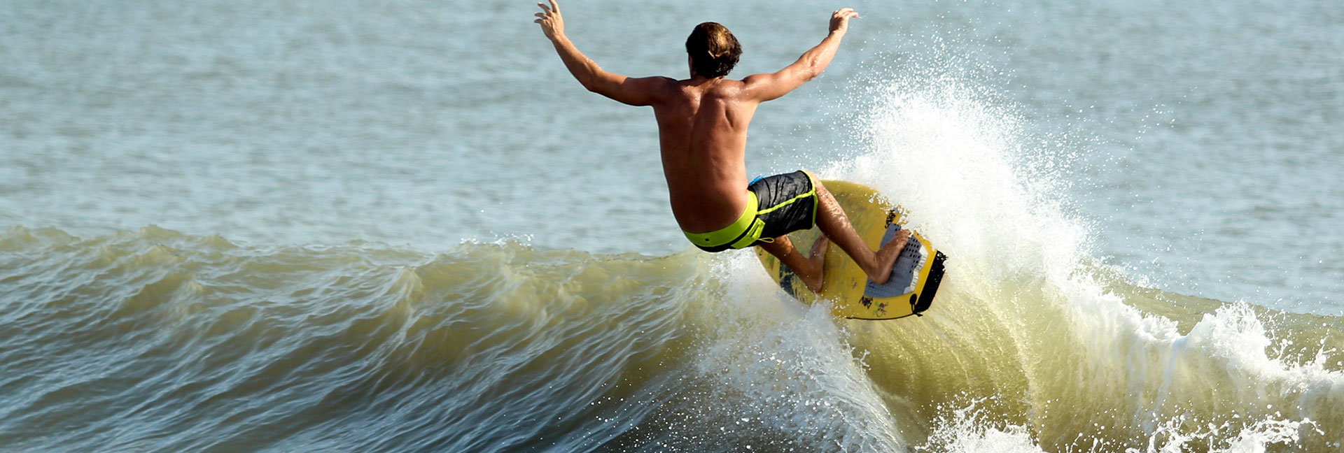 Wave Riding School - Brian Stoehr Surfing on yellow surfboard