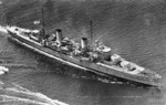 Light cruiser HMAS Perth entering port with her crew manning the rails, circa 1940