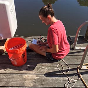 female student sitting on dock