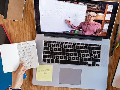 Student's desk with laptop and math notes.