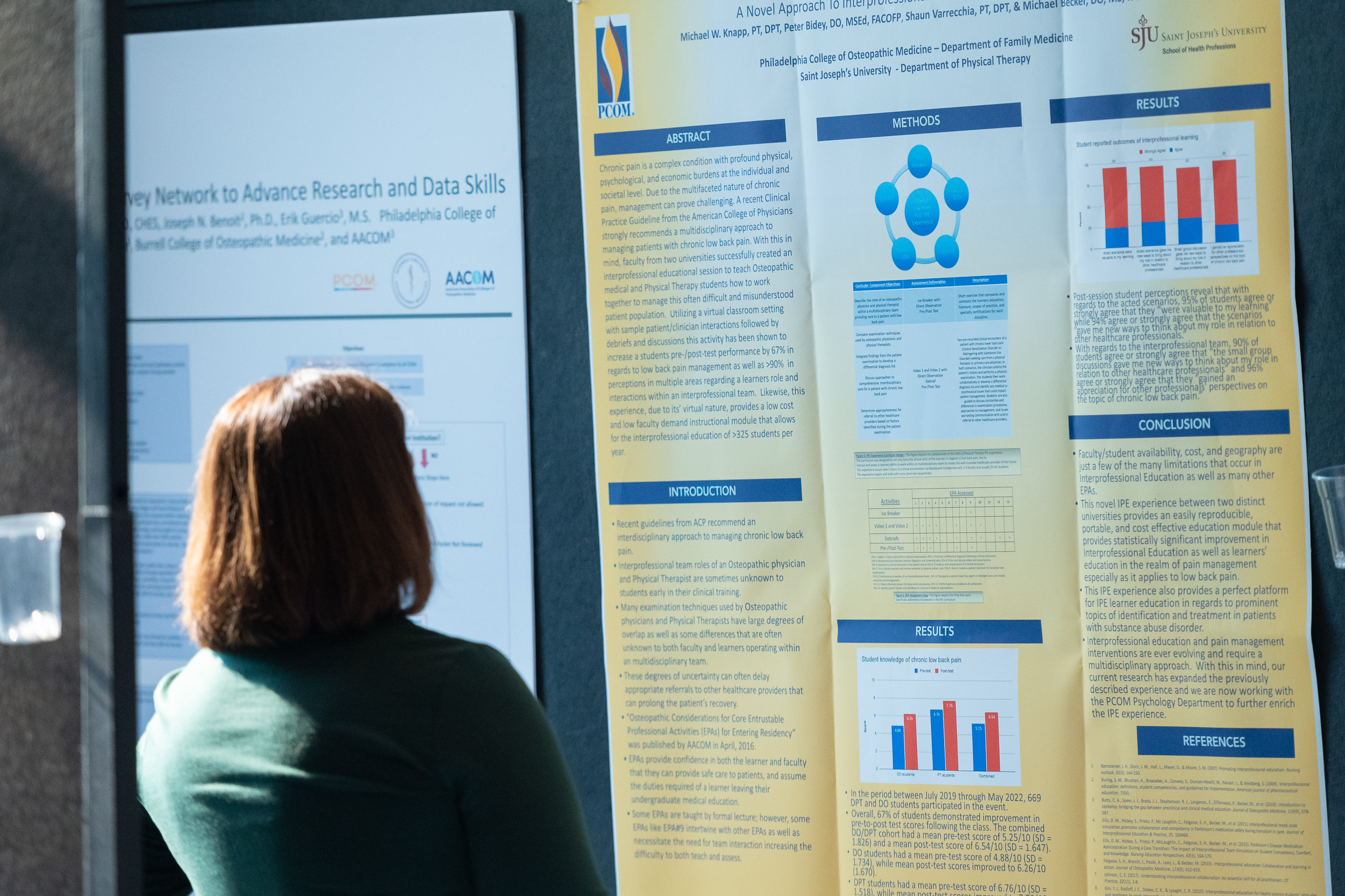 Photo of a woman looking at a poster