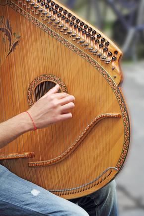 Man playing medieval lute on the street