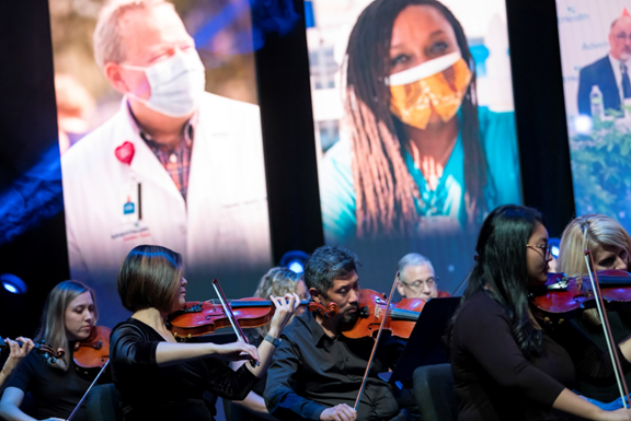 Vincent Hsu playing violin with the AdventHealth Orchestra.