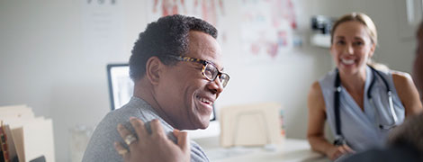 Patient laughing with his doctors as if sharing good news