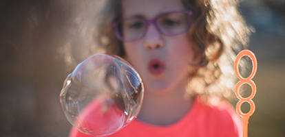 A woman blowing bubbles.