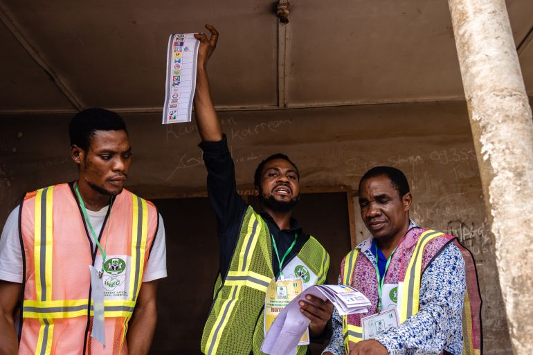 official holds up a ballot paper