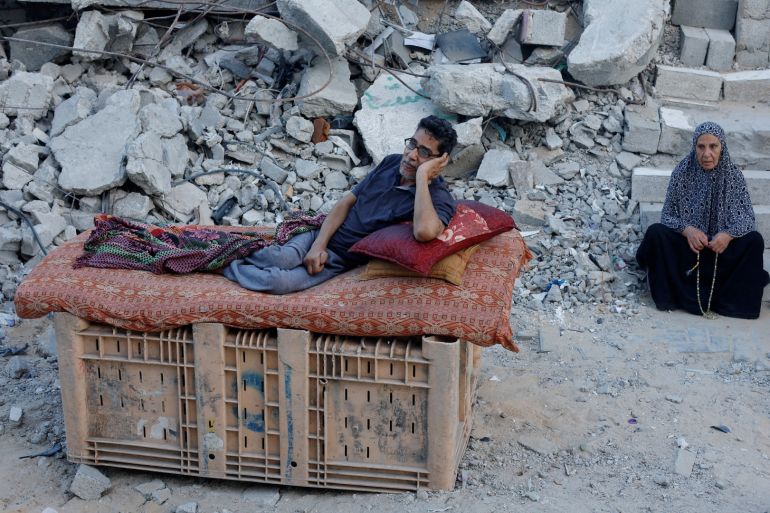 A Palestinian sits amidst the rubble of buildings destroyed after an Israeli strike, amid the ongoing conflict between Israel and Hamas, in Khan Younis, in the southern Gaza Strip September 1, 2024.