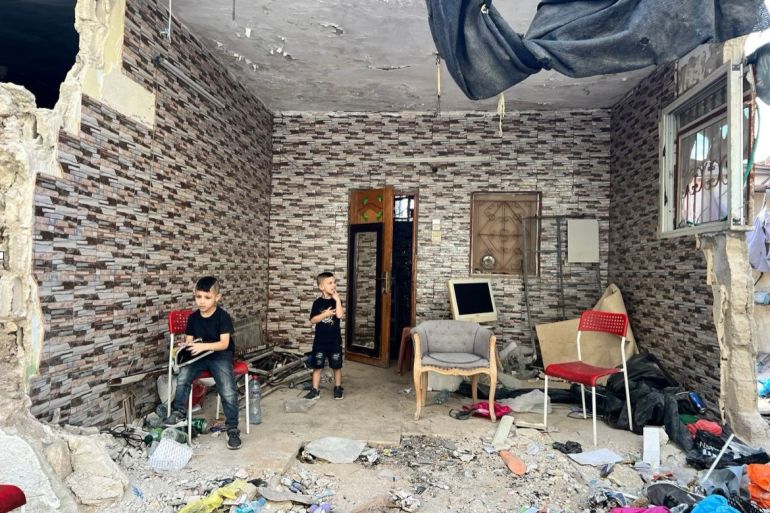 Rahim and Baraa, children of Akram Nassar, in their destroyed house, 16 September 2024 (Exclusive Al Jazeera)