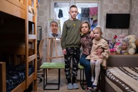 Natalia Sheleshei, 39, with her children, Yehor, 12, and Anastasia, 5, wait for the return of Serhii at their apartment in Ukraine&#039;s capital, Kyiv, on February 12 [Evgeniy Maloletka/AP Photo]