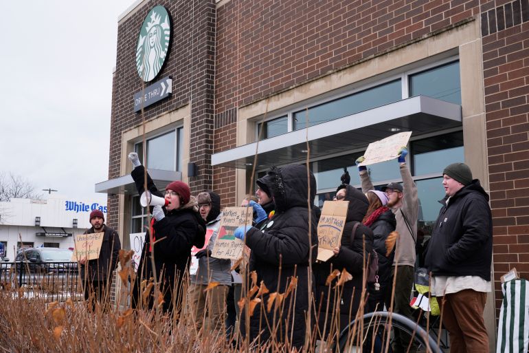 Employees picket outside a Starbucks store, Friday, Dec 20, 2024, in Chicago