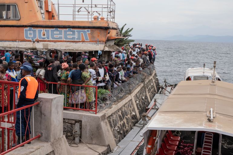 People gather at the port of Goma, Democratic Republic of Congo, after a ferry carrying hundreds capsized on arrival Thursday, Oct. 3, 2024. [AP Photo/Moses Sawasawa/file]