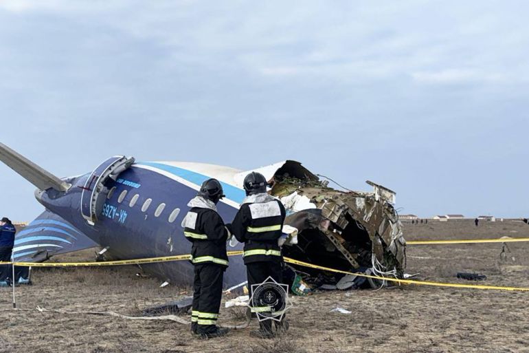 In this handout picture released by Kazakhstan's emergency situations ministry, emergency specialists work at the crash site of an Azerbaijan Airlines passenger jet near the western Kazakh city of Aktau on December 25, 2024. [Handout / Kazakhstan's emergency situations ministry / AFP]