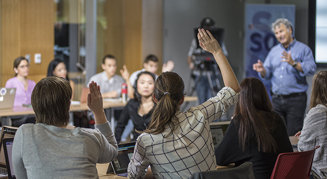 Students raise their hands in 2016 election class with AU professor Lenny Steinhorn