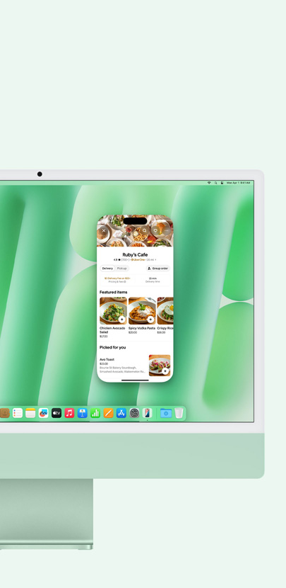 Una iMac verde muestra el uso de Duplicación del iPhone y la app Mensajes en la pantalla.