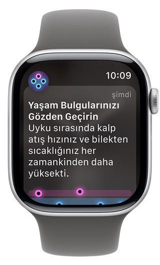 Apple Watch ekranında bir uyarı görünüyor: "Yaşam Bulgularınızı Gözden Geçirin"