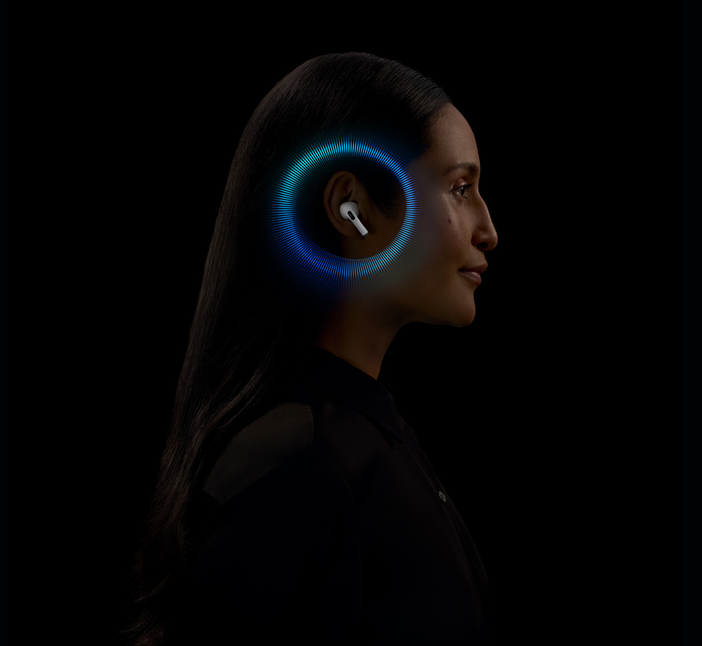 A person wearing AirPods Pro 2 with soundwaves around their ear.