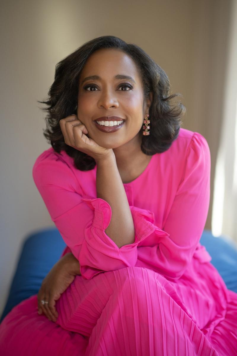 Color photograph of black woman in a pink dress