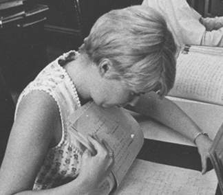 Woman looking through sheaf of papers