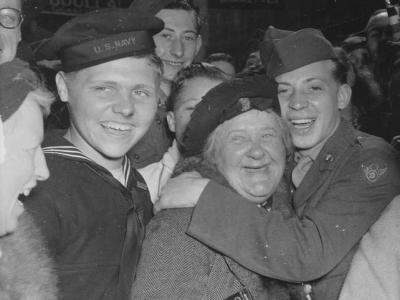 people cheering on V-E Day in London