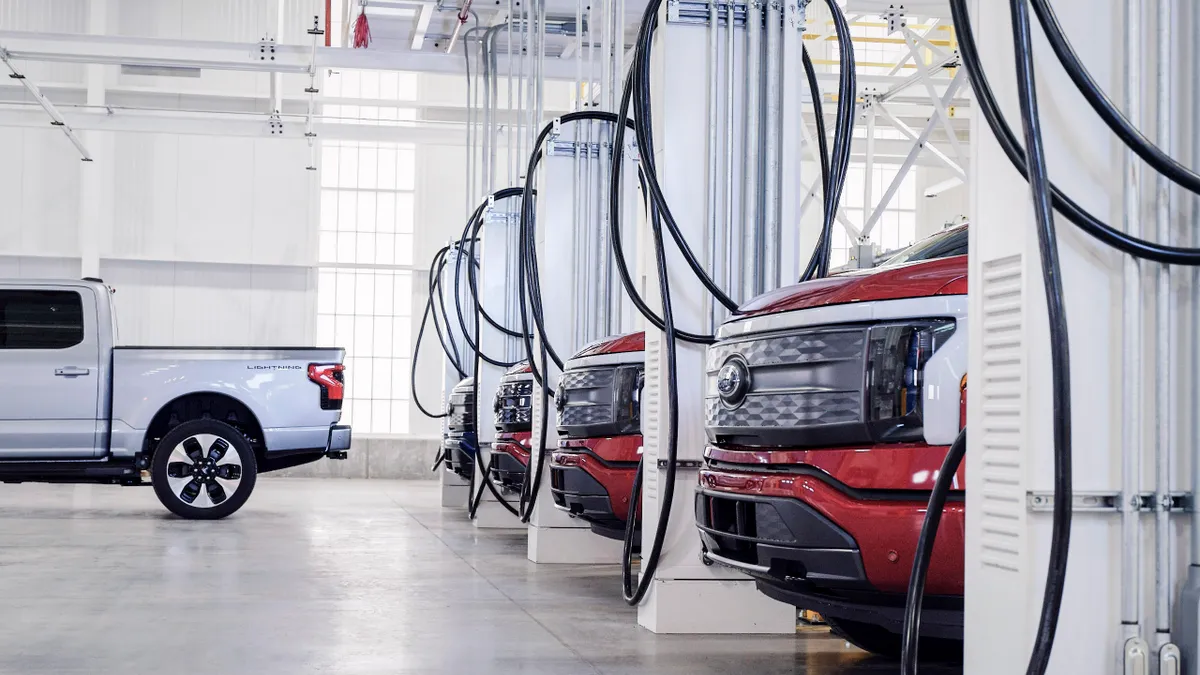 A row of Ford F-150 Lighting pickups parked inside the automaker's Rouge Electric Vehicle Center in Michigan.