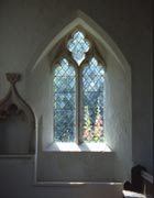 Leaded church window with garden visible outside