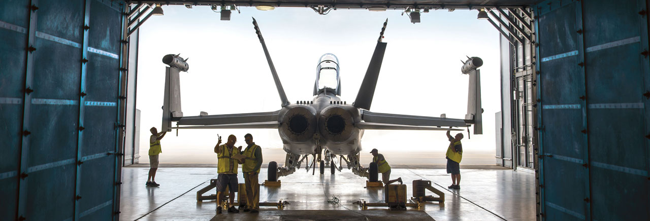 Employees working on a fighter jet.