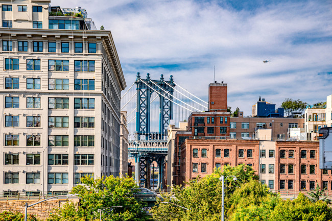 Dumbo is a vibrant Brooklyn neighborhood known for its artistic scene, offering spectacular views of the iconic Steel Manhattan Bridge. stock photo