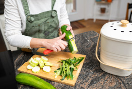 Women cooking uses compost bin