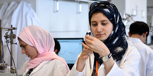 Two students working in a laboratory.