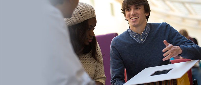 A white man and a black woman talking and smiling.