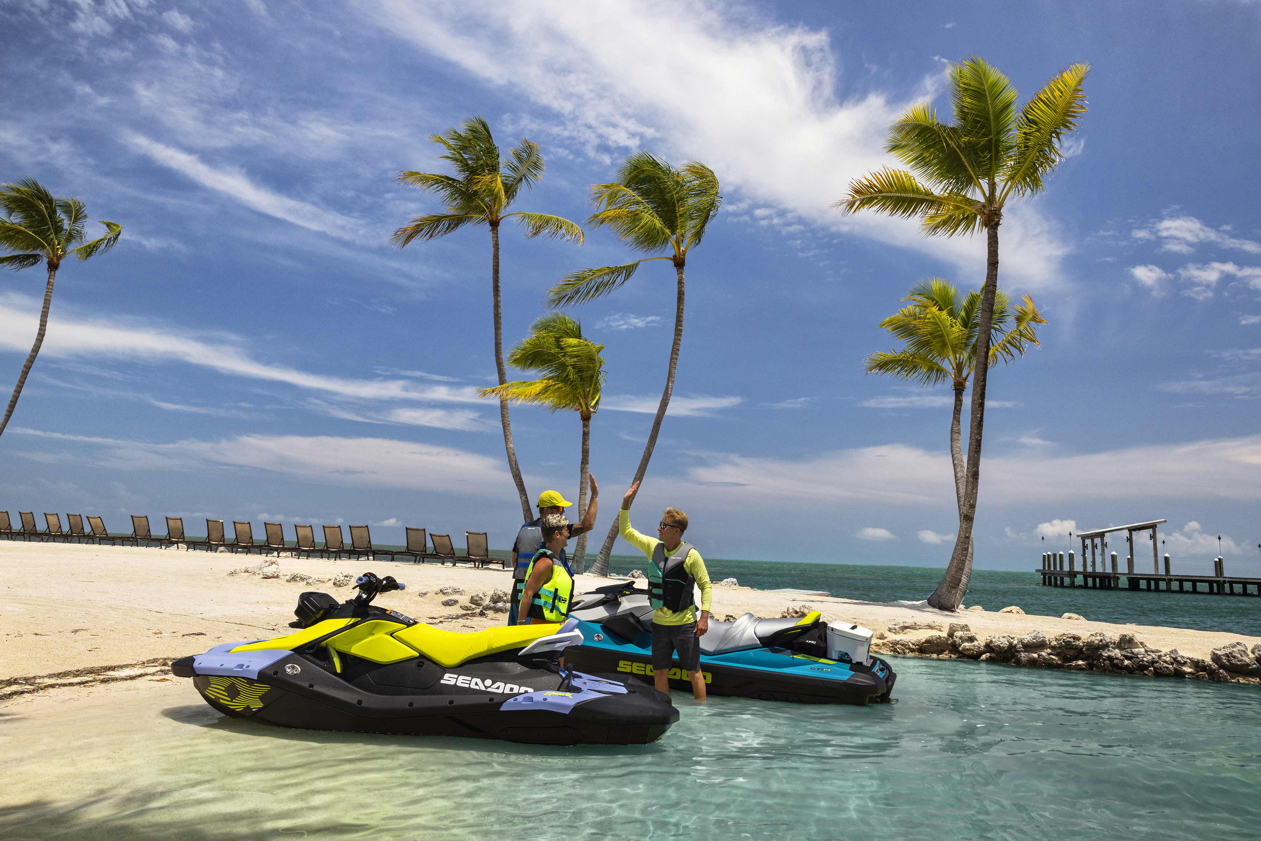 Three friends with two Sea-Doo Spark personal watercrafts