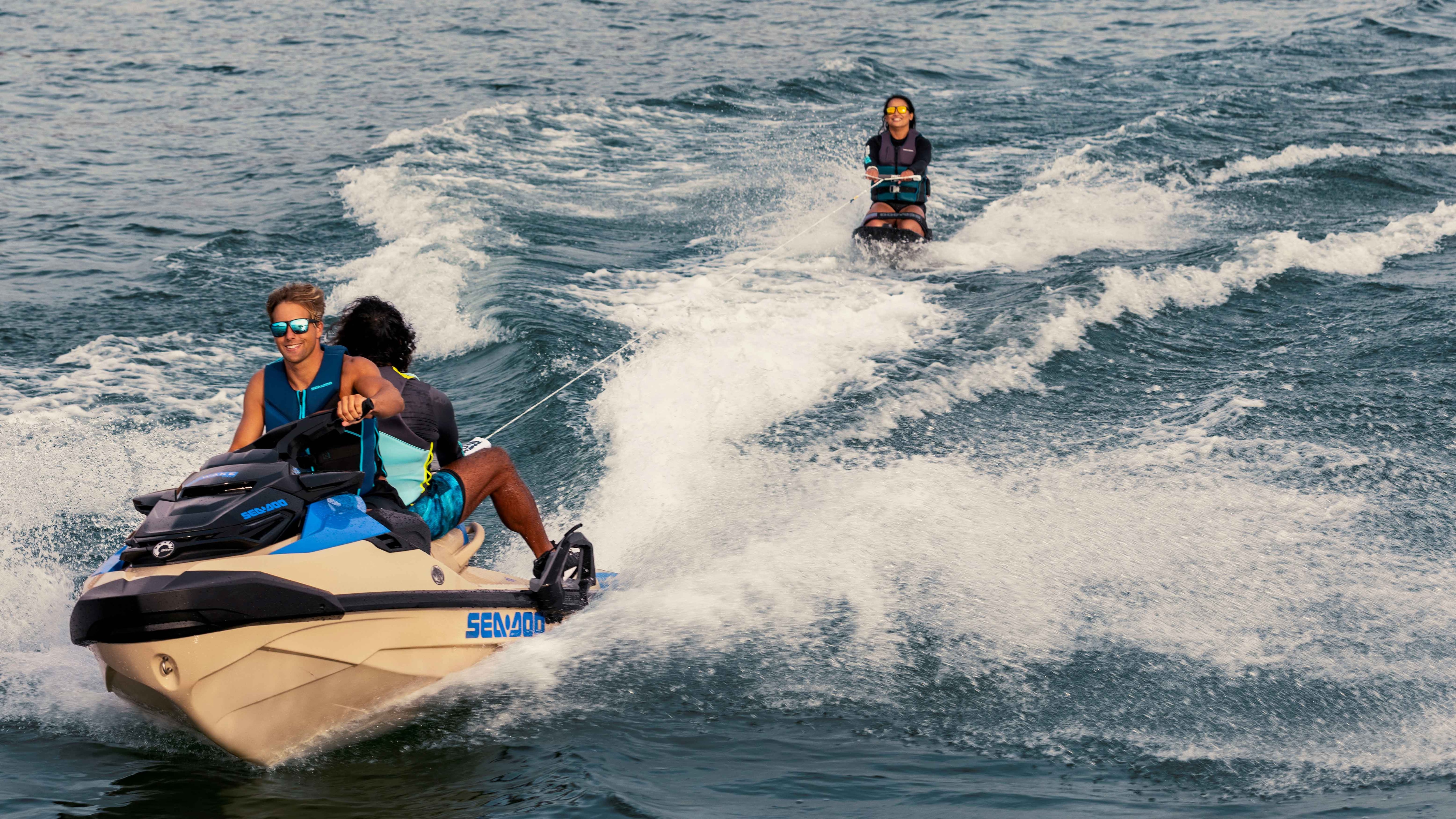 Three friends having fun riding a Sea-Doo Wake Pro