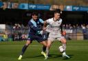 Wycombe Wanderers's Ryan Trafazolli (left) and Portsmouth's Colby Bishop (right) battle for the