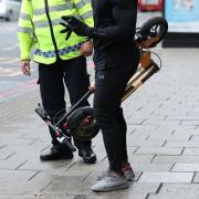 An e-scooter rider is stopped by a police officer in Islington, London, during an operation to educate them as to the risks associated with the use of e-scooters, which are currently illegal to use on the public highways including pavements.