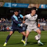 Wycombe Wanderers's Ryan Trafazolli (left) and Portsmouth's Colby Bishop (right) battle for the