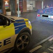 Police pull over black BMW covered in Christmas lights in Aylesbury