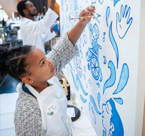 Young student painting at the Student-Centered Learning for Equity Conference.