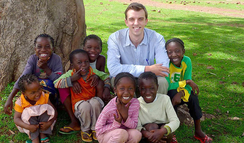 Photo of an intern with a group of small children.