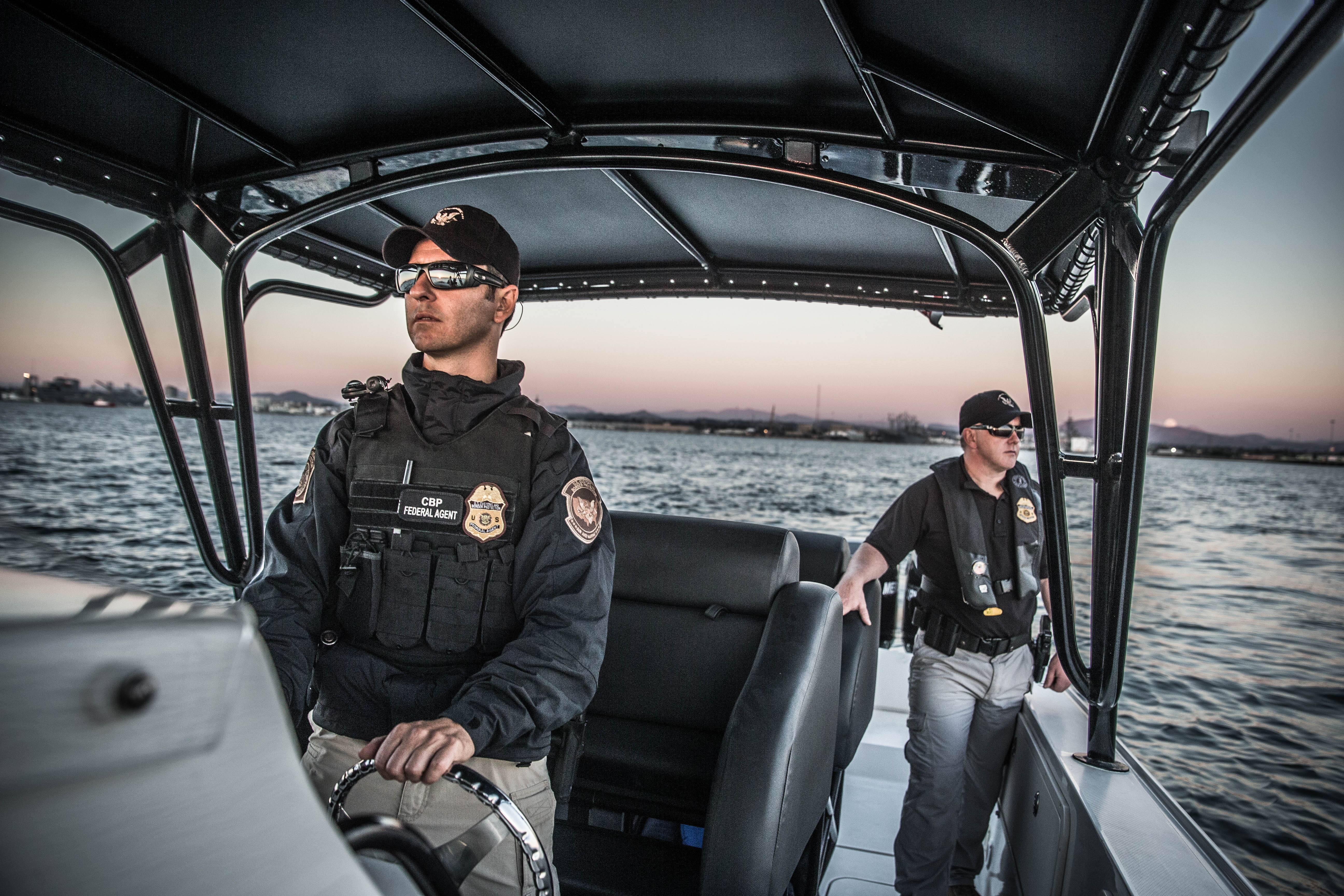 An Air and Marine Operations Marine Interdiction Agent conducts a maritime patrol while another crewmember keeps an eye out for suspicious activity near San Diego, California.