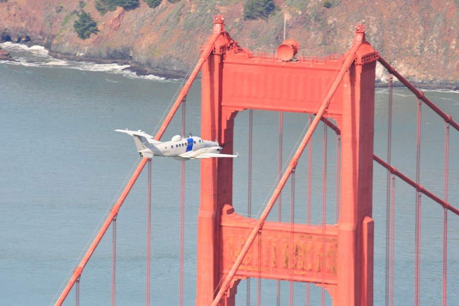 An MEA crew flies overhead during preparations for Super Bowl 50.