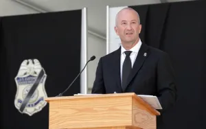 Senior Official Performing the Duties of the Commissioner Troy A. Miller stands at a podium speaking to attendees.