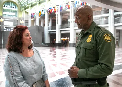 Lisa Santana Fox and Clarence Catchings talking in RRB atrium.