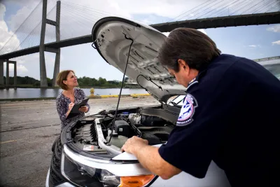 Tracey Marquez and Craig Richmond at the port of Savannah examining a stolen vehicle’s vin number