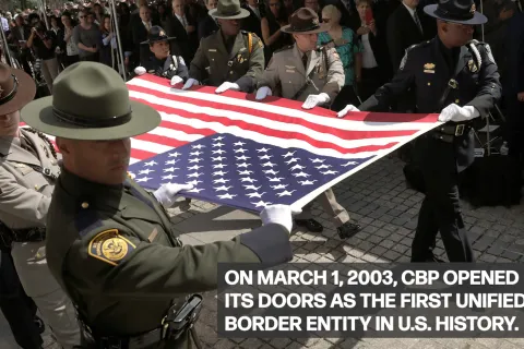 CBP Officers and Agents hold the US Flag flat